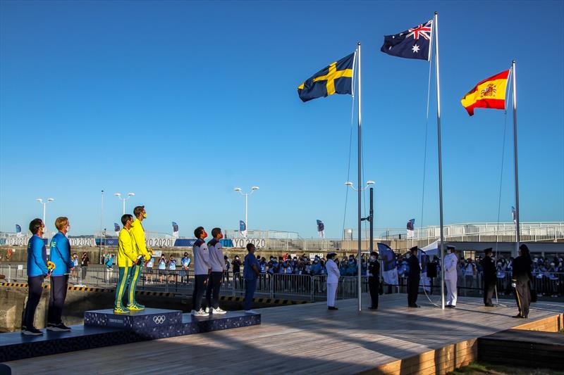 Mat Belcher and Will Ryan whatch as the Australian flag is hoisted at the Medal ceremony for the Mens 470 - Tokyo2020 - Day 10 - August 4, , Enoshima, Japan photo copyright Richard Gladwell - Sail-World.com / nz taken at  and featuring the 470 class