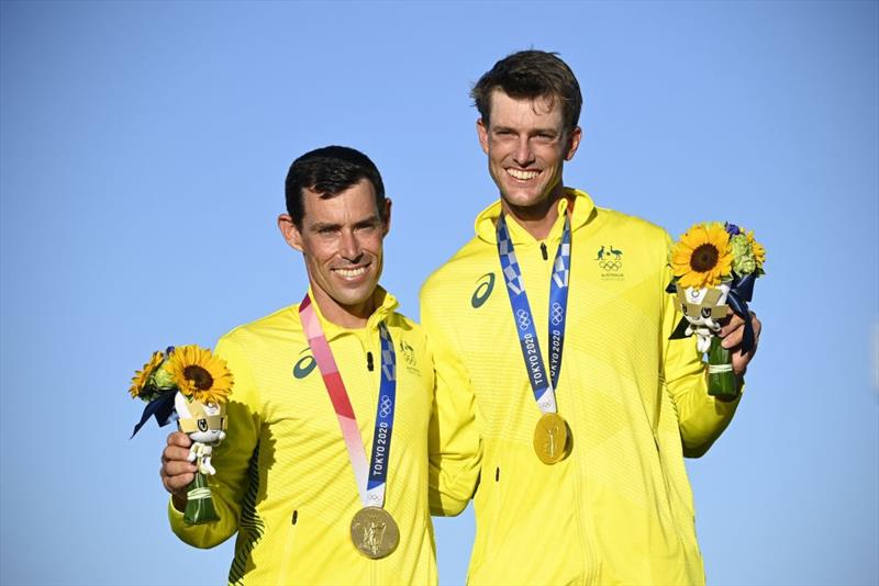 (L-R) Gold medallists Australia's Mathew Belcher and Will Ryan celebrate on the podium after the men's two-person dinghy 470 medal race during the Tokyo 2020 Olympic Games sailing competition at the Enoshima Yacht Harbour photo copyright Olivier Morin / AFP taken at  and featuring the 470 class