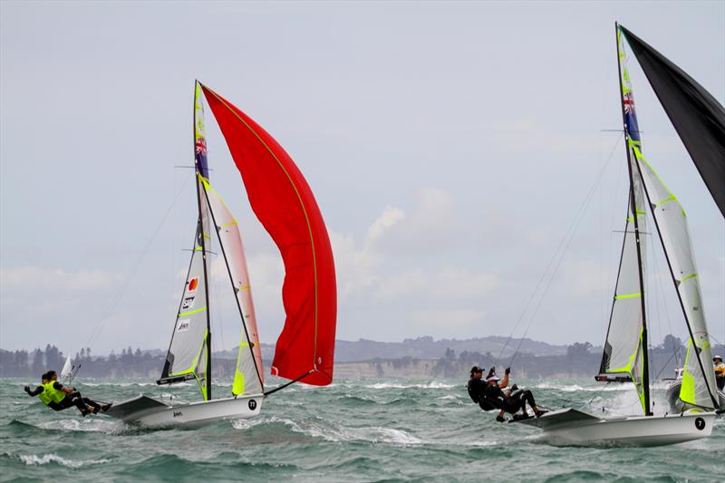 Logan Dunning Beck and Oscar Gunn (7) focus on the finish of the Medal race, while behind them the backslaps and embraces begin for Peter Burling and Blair Tuke - 49er Hyundai Worlds - December  2019 photo copyright Richard Gladwell / Sail-World.com taken at Royal Akarana Yacht Club and featuring the 49er class