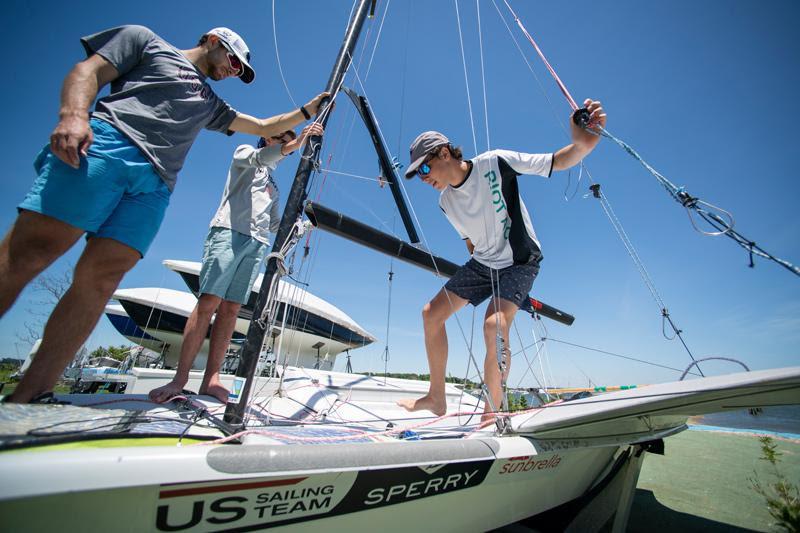 Trainees worked with coach Nate Housberg on rigging a 49er photo copyright Lexi Pline taken at Oakcliff Sailing Center and featuring the 49er class