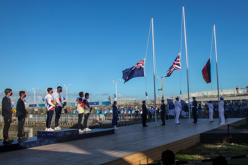 Peter Burling and Blair Tuke (NZL) watch the NZ flag being raised- 49er Medal ceremony - Tokyo2020 - Day 9- August 2, - Enoshima, Japan photo copyright Richard Gladwell - Sail-World.com / Photosport taken at Royal New Zealand Yacht Squadron and featuring the 49er class