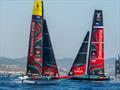 Emirates Team New Zealand AC 40, passes to windward of the AC75 in Barcelona