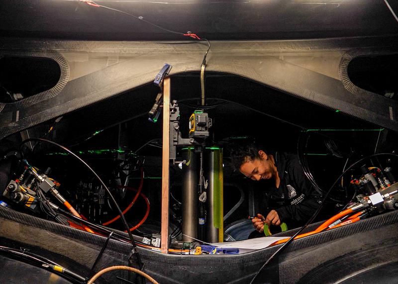 Kelly Hartzell of ETNZ's Mechatronincs Team works inside the AC40 hull prior to stress testing - September 2022 - photo © Emirates Team NZ