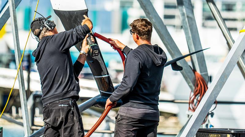 Working on the foil arm repair - Emirates Team New Zealand - AC40 - LEQ12 - Day 23, May 17, 2023 photo copyright Adam Mustill/America's Cup taken at Royal New Zealand Yacht Squadron and featuring the AC40 class