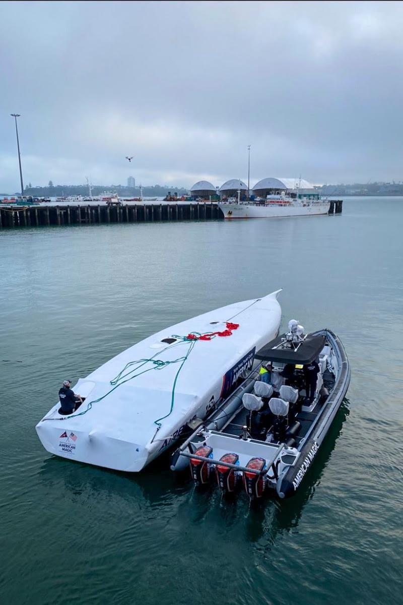 Defiant guided towards her new home at the American Magic base shortly after being unloaded from the ship photo copyright American Magic taken at  and featuring the AC75 class