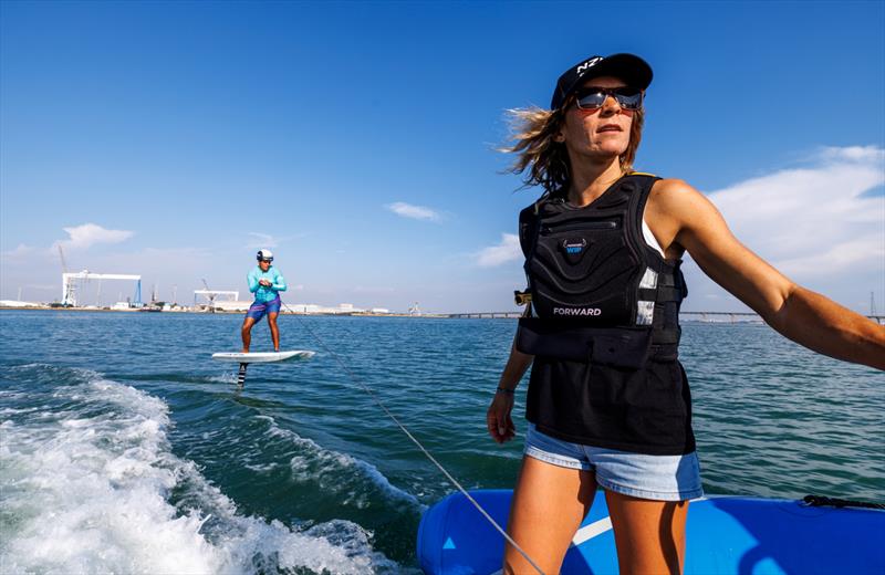 Jo Aleh, strategist of New Zealand SailGP Team, gives tips to the young sailors in the SailGP Inspire program trying out the Armstrong foil board ahead of the Spain Sail Grand Prix in Cadiz, Andalusia, Spain. 22nd September  - photo © Felix Diemer/SailGP