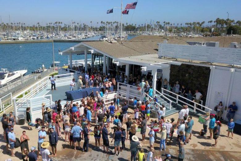 A crowd gathers for the presentation of the Jessica Uniack Memorial Trophy, awarded to the winning sailing of the largest fleet photo copyright Cameron MacLaren taken at Long Beach Yacht Club and featuring the Dinghy class