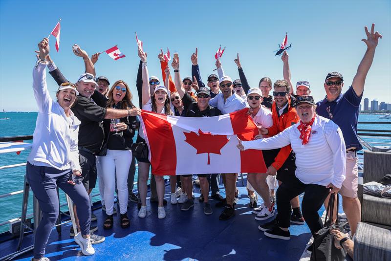 Jubilant supporters of the Canada SailGP Team hold the flag as they watch the action from the Adrenaline Lounge spectator boat on Race Day 1 of the T-Mobile United States Sail Grand Prix | Chicago at Navy Pier, Lake Michigan, Season 3 June 2022 - photo © Katelyn Mulcahy/SailGP