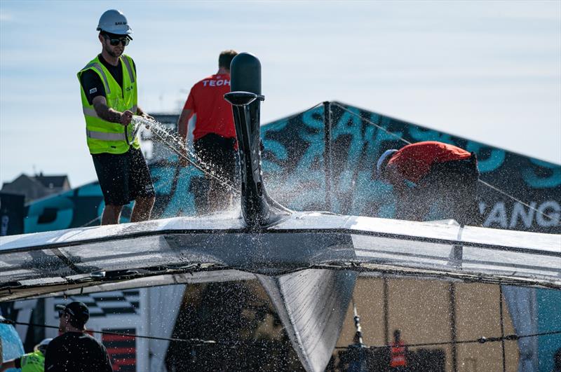 Crew member clean a F50 catamaran at the Technical Base after a practice session ahead of the Great Britain Sail Grand Prix | Plymouth in Plymouth, England. 29th July 2022 photo copyright Jon Super/SailGP taken at Royal Plymouth Corinthian Yacht Club and featuring the F50 class