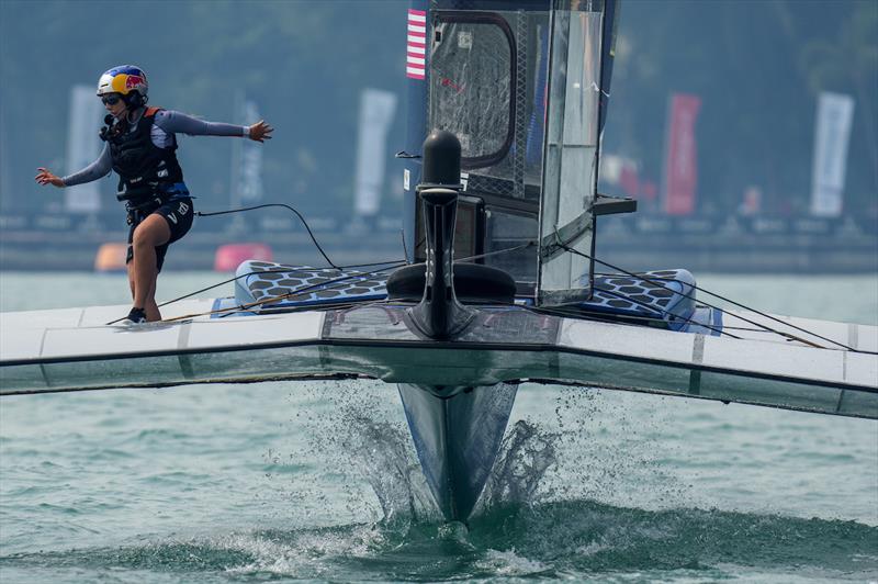 CJ Perez, strategist of USA SailGP Team, runs across the F50 as the USA SailGP Team helmed by Jimmy Spithill racing during the second race on Race Day 1 of the Singapore Sail Grand Prix presented by the Singapore Tourism Board photo copyright Eloi Stichelbaut for SailGP taken at  and featuring the F50 class