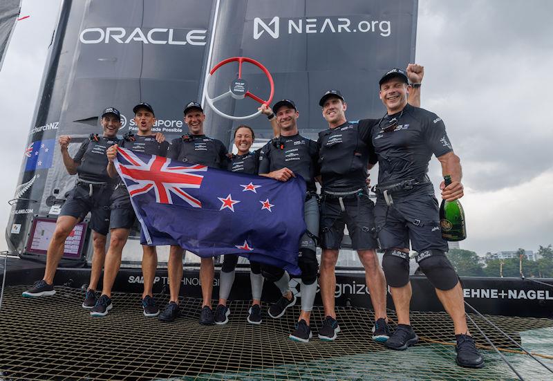The New Zealand SailGP Team crew celebrate their win on their F50 with Champagne Barons de Rothschild and their national flag on Race Day 2 of the Singapore Sail Grand Prix presented by the Singapore Tourism Board photo copyright Felix Diemer for SailGP taken at  and featuring the F50 class
