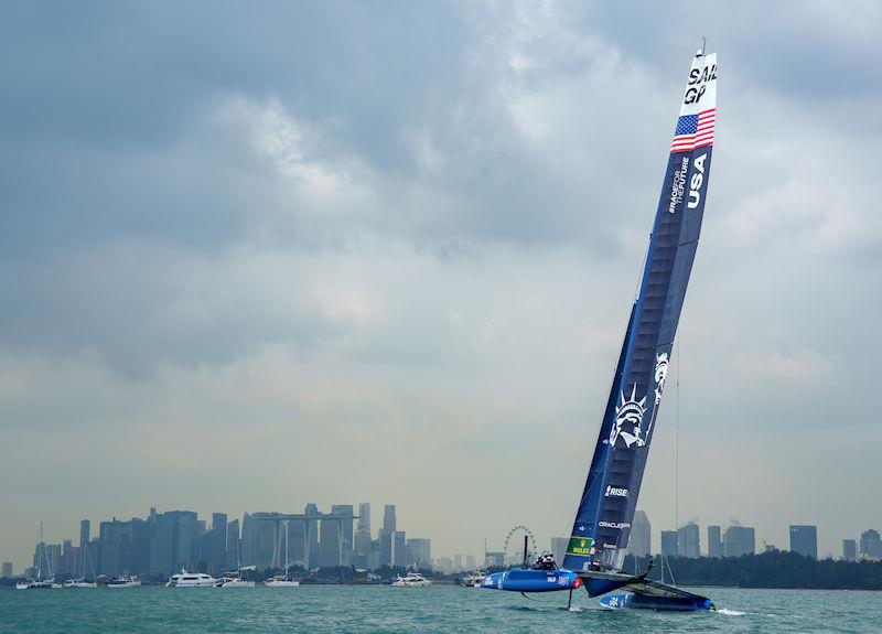 USA SailGP Team helmed by Jimmy Spithill warm up ahead of Race One with the Marina Bay Sands Hotel and the city skyline behind on Race Day 2 of the Singapore Sail Grand Prix presented by the Singapore Tourism Board photo copyright Bob Martin for SailGP taken at  and featuring the F50 class
