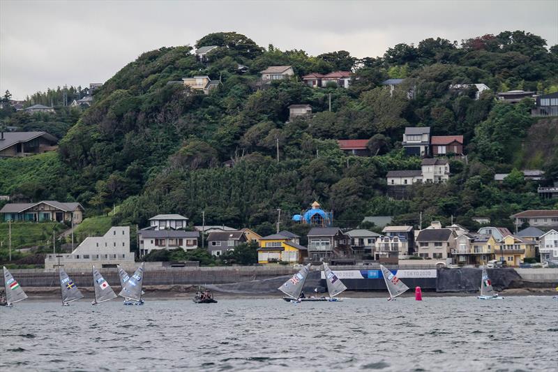 Tokyo2020 - Day 1 of the Finn class with the top mark dropped in front of a high bluff and close to shore - with a light offshore breeze. Three of the top five overall scored their discard in the opening race photo copyright Richard Gladwell - Sail-World.com/nz taken at Wakatere Boating Club and featuring the Finn class