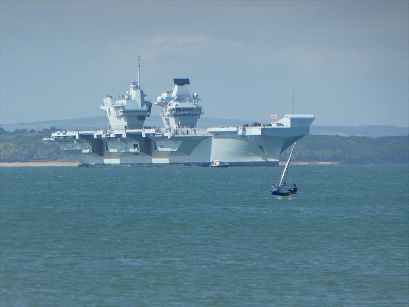 Moth and HMS Queen Elizabeth II off Stokes Bay photo copyright John Donnelly taken at Stokes Bay Sailing Club and featuring the International Moth class