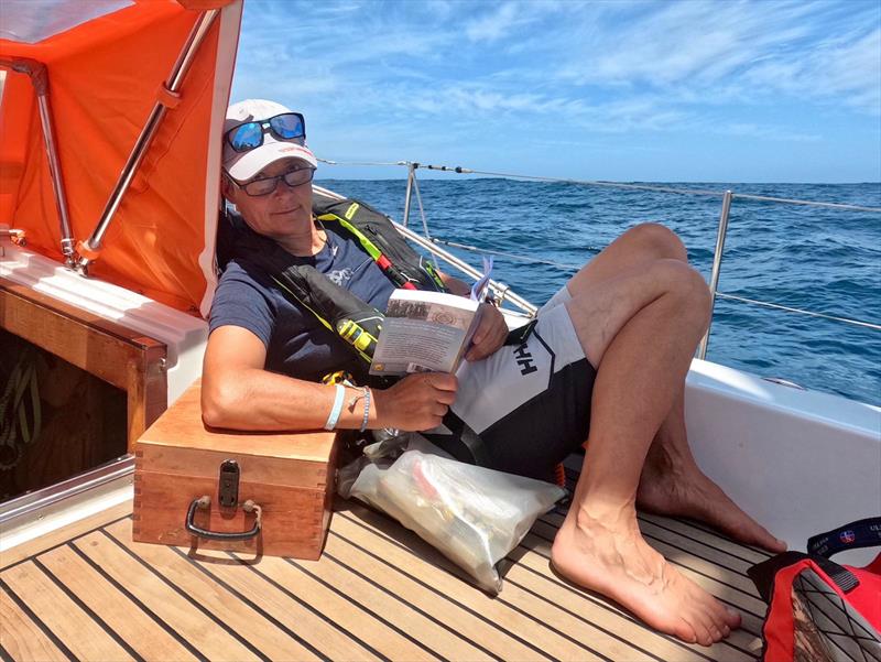 Heike Merbold reads a book on the history of the sextant while leaning on a sextant. At sea Nov 27, 2023  photo copyright Team Explorer / OGR taken at Royal Cape Yacht Club and featuring the IOR class
