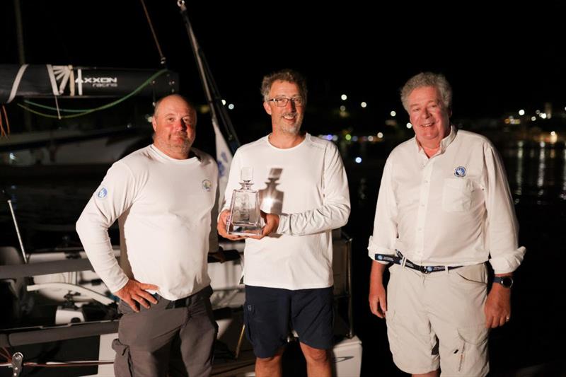 Andrew Mcirvine, IMA Secretary General and past RORC Admiral greets Team Jangada and presents them with the trophy for winning the RORC Transatlantic Race IRC Two-Handed class photo copyright Arthur Daniel / RORC taken at Royal Ocean Racing Club and featuring the IRC class