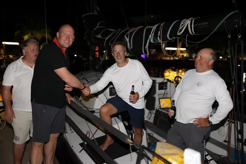 Scarlet Oyster's Ross Applebey welcomes Richard Palmer and Jeremy Waitt after finishing the RORC Transatlantic Race photo copyright Arthur Daniel / RORC taken at Royal Ocean Racing Club and featuring the IRC class
