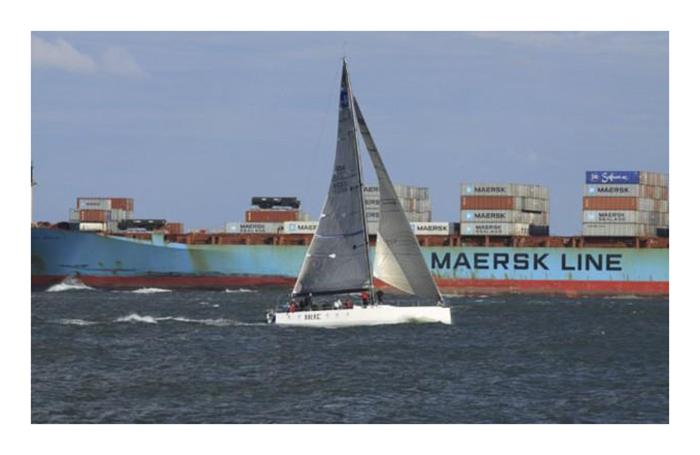 Irie, a TP52 skippered by Greg Alden, set the elapsed time record for the Down the Bay Race in 2013. Irie, shown with a passing freighter as backdrop, completed the 120-nautical mile course in 7hrs, 2mins & 32secs to smash a mark that had stood since 1974 photo copyright Bill Wagner taken at Hampton Yacht Club and featuring the J105 class