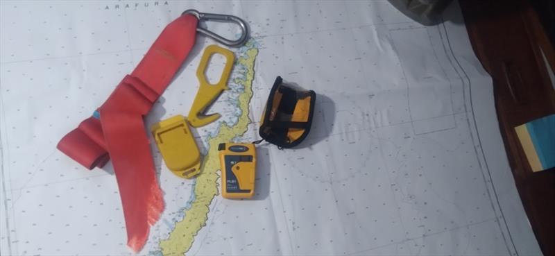 Nigel Fox's equipment - the Ocean Signal rescueME PLB1, alongside the hook knife he used to cut the jack line photo copyright Nigel Fox taken at 