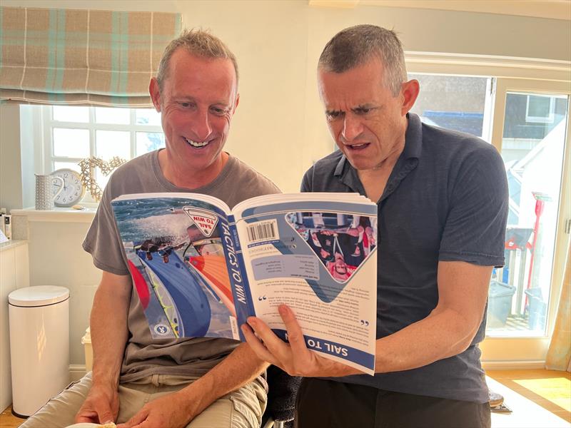 Martin Booth and Alan Mclean consult the tactics book photo copyright Steve Fraser taken at East Lothian Yacht Club