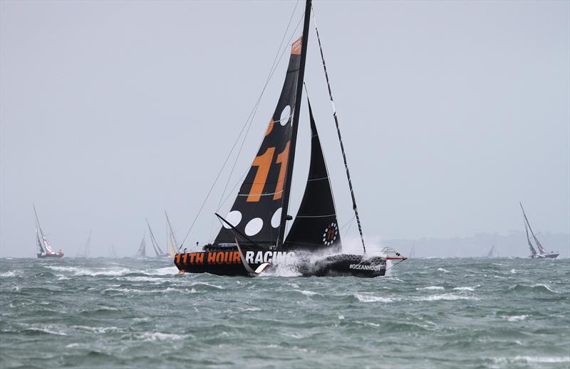 11th Hour Racing Team passes Hurst Castle after the Rolex Fastnet Race start photo copyright Mark Jardine taken at Royal Ocean Racing Club and featuring the IMOCA class