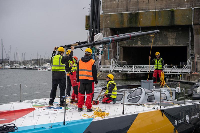 Craning and installing the mast, boom, and outriggers back on the boat is a delicate operation which requires well-executed coordination by the tech team photo copyright Marie Lefloch / Team Malizia taken at  and featuring the IMOCA class