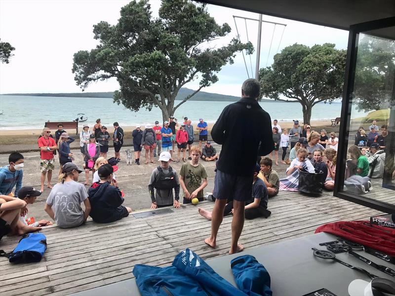 America's Cup winner Richard Meacham gets the Opti Open & Opti White prizegiving underway for the Auckland Optimist Championships. The winners medals can be glimpsed in the lower right corner. - photo © Wakatere BC Media