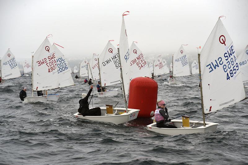 34th Palamós Optimist Trophy day 1 -  Swedish crews at the head of the fleet in the fog photo copyright Alfred Farré taken at Club de Vela Palamos and featuring the Optimist class