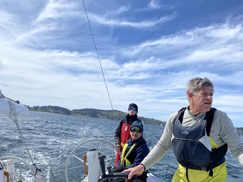 Libby McKee drives the uphill leg of the 2024 Blakely Rock Benefit Race, while Mark Reed trims main and Jonathan McKee keeps his eyes out of the boat photo copyright David Schmidt taken at Seattle Yacht Club and featuring the PHRF class