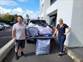 Raynor Haagh, Yachting NZ's National Sport Development Director, and regional development manager Hayden Whitburn with items donated by the organisation © Yachting NZ