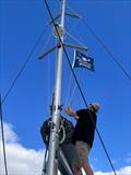 Island Cruising Pacific Rally Sets Sail - Roger from Aroha raises the Pacific Rally flag
